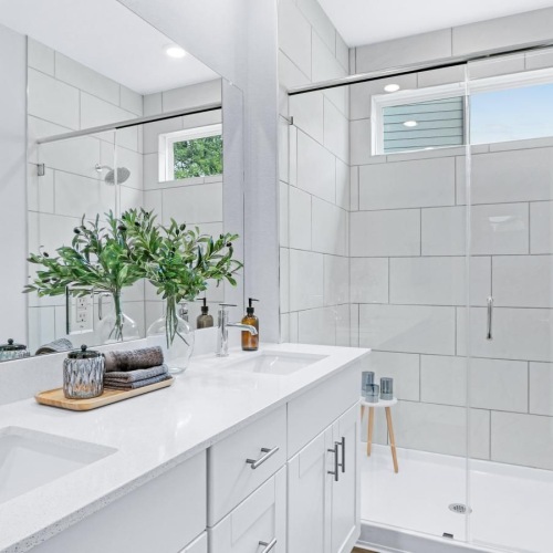 a bathroom with a tub sink and a mirror