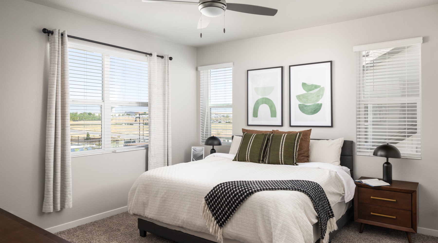 a bedroom with a bed and a fan